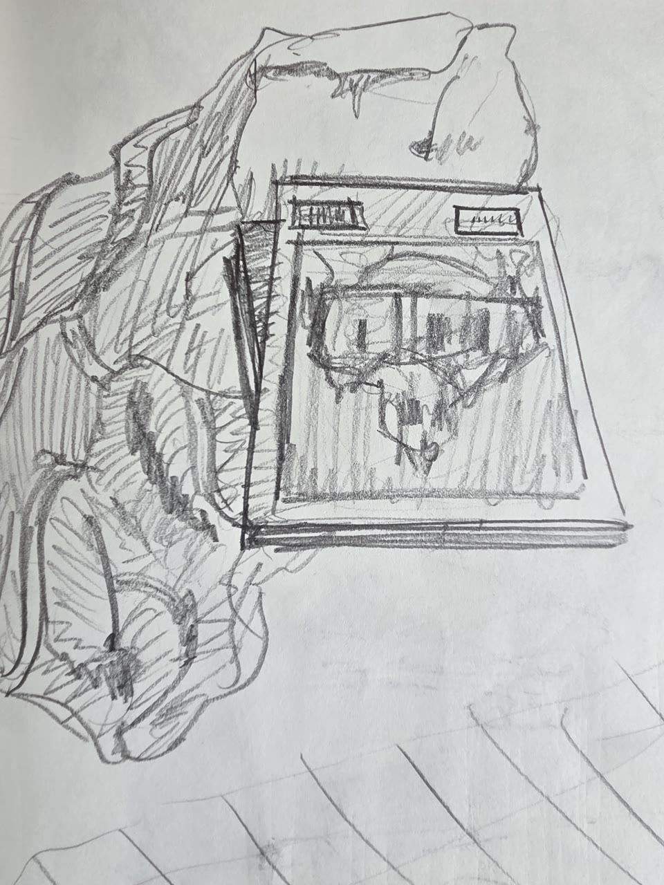 Graphite sketch of a fabric pile beside a tablet or screen