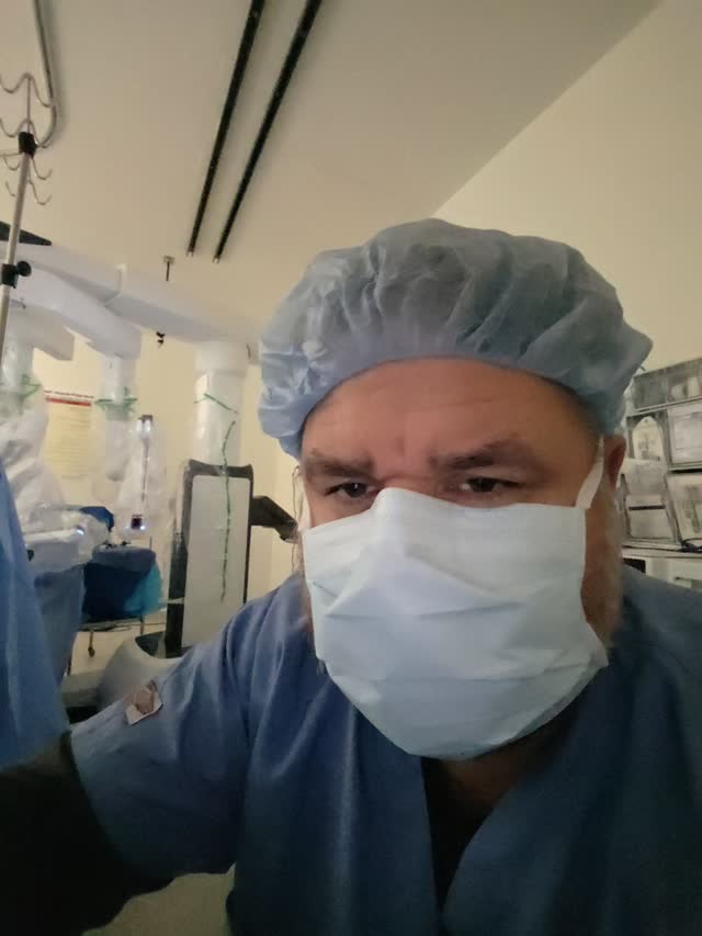 Moses Olson, MD in surgical attire